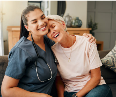 nurse and senior woman laughing together