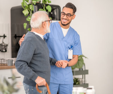 male carer assisting an elderly man